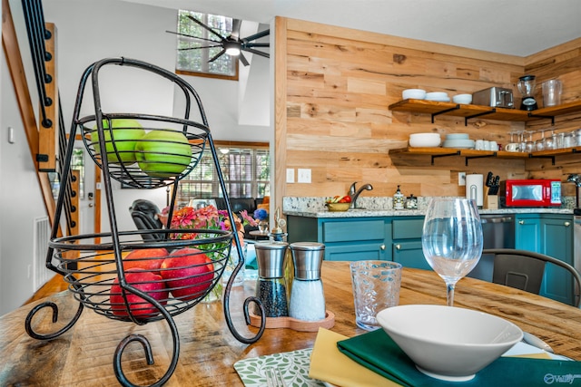 dining area featuring wood walls, ceiling fan, and hardwood / wood-style flooring