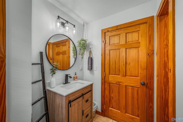 bathroom featuring a textured ceiling, vanity, and tile patterned floors