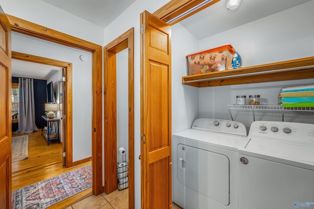 washroom featuring light hardwood / wood-style flooring and washing machine and dryer