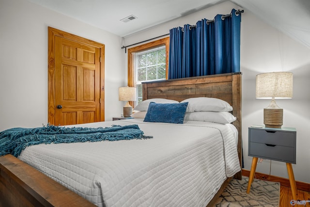 bedroom featuring wood-type flooring and lofted ceiling