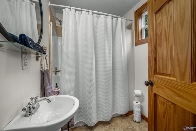 bathroom featuring walk in shower and tile patterned flooring