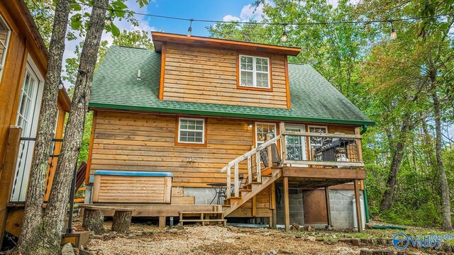 rear view of property featuring a wooden deck