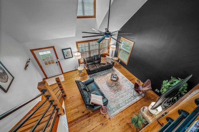 living room with ceiling fan, lofted ceiling, and hardwood / wood-style floors