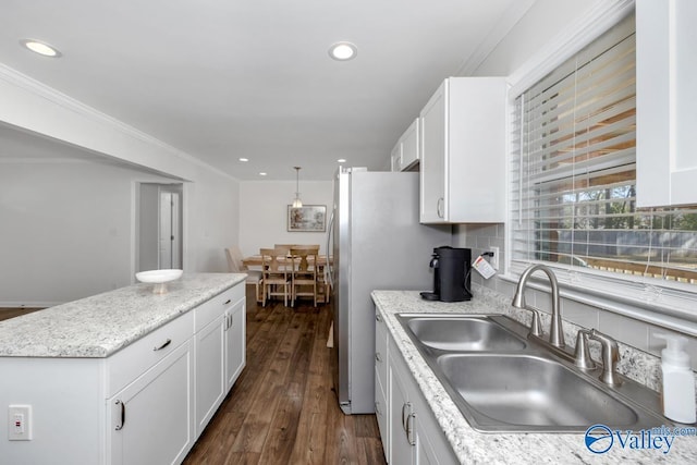 kitchen with ornamental molding, dark hardwood / wood-style flooring, sink, and white cabinets