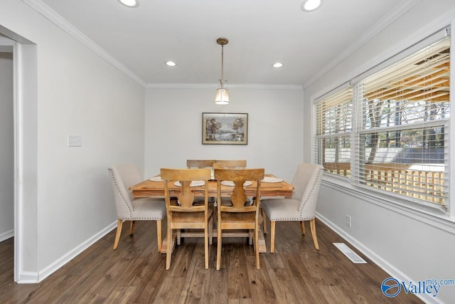 dining room featuring crown molding and dark hardwood / wood-style floors