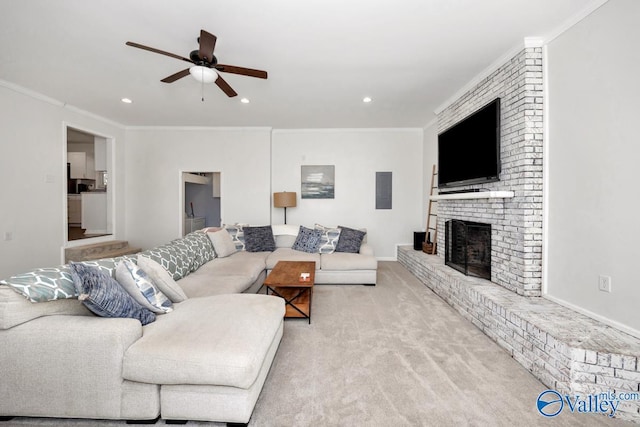 living room with crown molding, ceiling fan, a fireplace, and light carpet