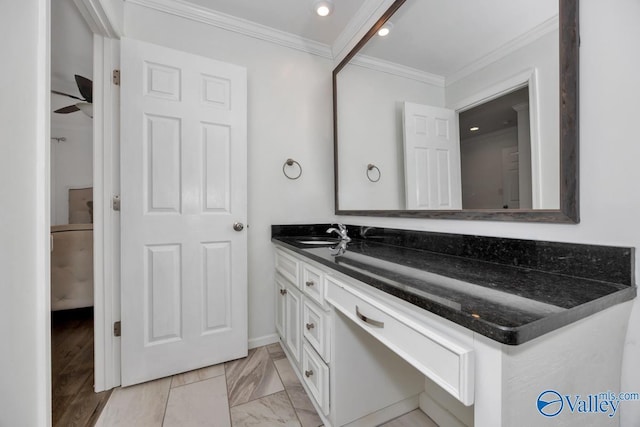 bathroom featuring ceiling fan, ornamental molding, and vanity