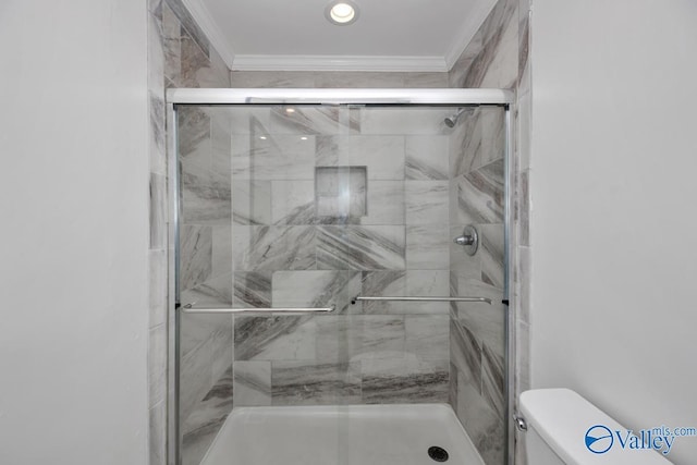 bathroom featuring crown molding and a shower with shower door