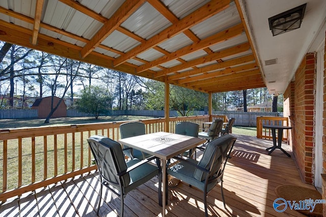 wooden deck featuring a lawn