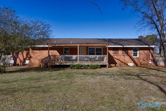 rear view of house with a yard and a deck