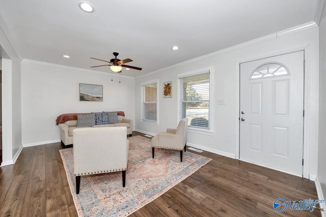 living room with ornamental molding, dark hardwood / wood-style floors, and ceiling fan