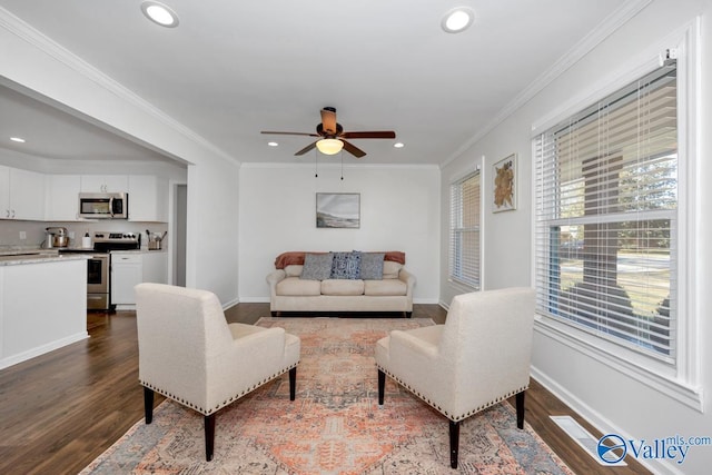 living room with crown molding, ceiling fan, and hardwood / wood-style flooring