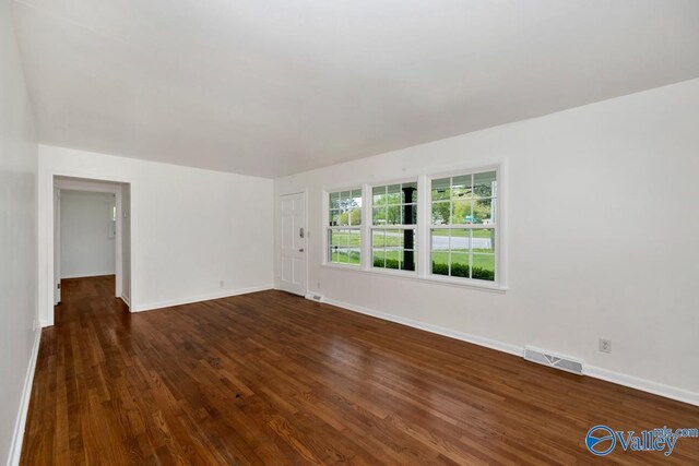 4407 Sparkman Dr NW, Huntsville, AL 35810 - unfurnished room with dark wood-style flooring, baseboards, and visible vents