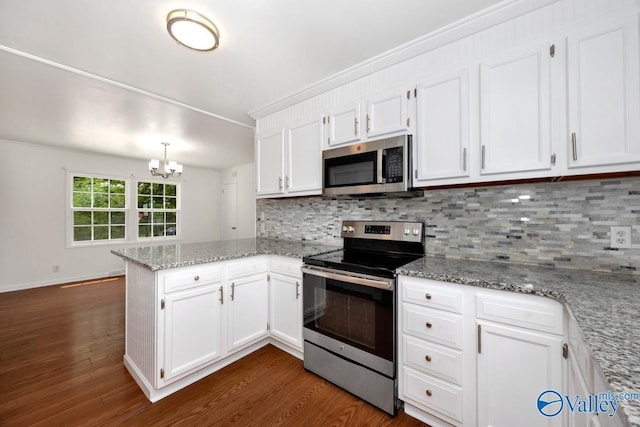 4407 Sparkman Dr NW, Huntsville, AL 35810 - kitchen with white cabinetry, appliances with stainless steel finishes, a peninsula, and dark wood-style floors