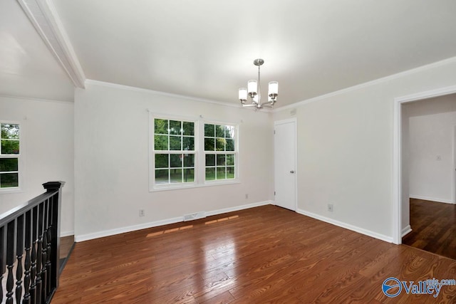 4407 Sparkman Dr NW, Huntsville, AL 35810 - spare room with baseboards, ornamental molding, a chandelier, visible vents, and wood finished floors
