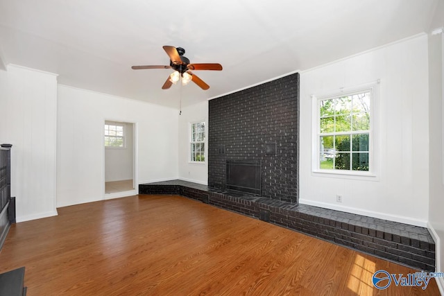 4407 Sparkman Dr NW, Huntsville, AL 35810 - unfurnished living room featuring wood finished floors, ceiling fan, baseboards, and a brick fireplace