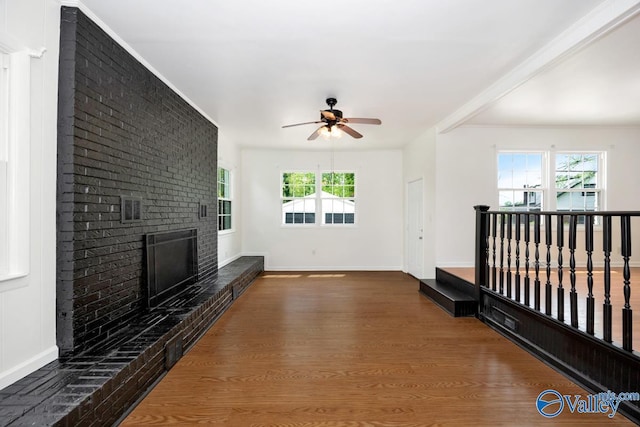 4407 Sparkman Dr NW, Huntsville, AL 35810 - unfurnished living room with wood finished floors, a fireplace, a ceiling fan, and baseboards