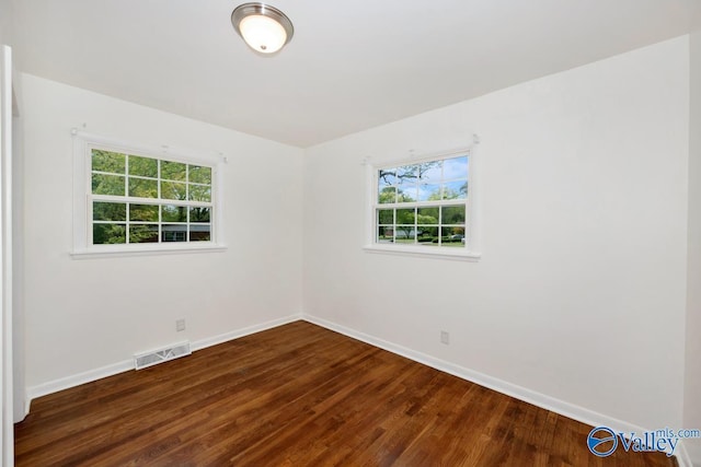 4407 Sparkman Dr NW, Huntsville, AL 35810 - unfurnished room with visible vents, baseboards, and dark wood-style floors