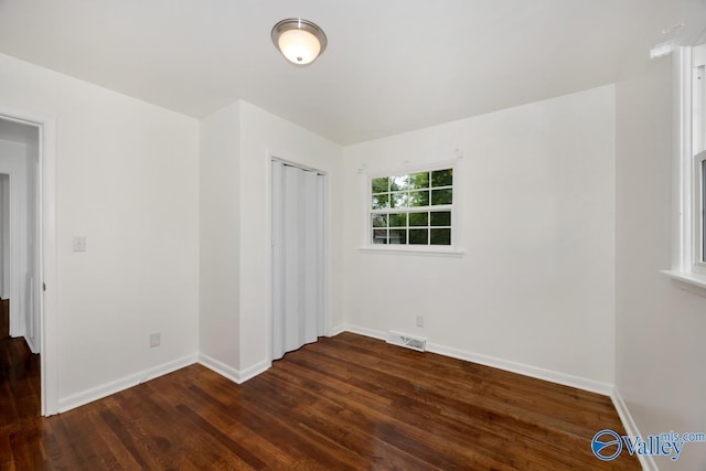 4407 Sparkman Dr NW, Huntsville, AL 35810 - spare room featuring dark wood-type flooring, visible vents, and baseboards
