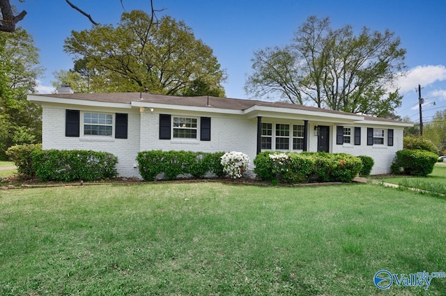 4407 Sparkman Dr NW, Huntsville, AL 35810 - ranch-style home featuring brick siding, a front lawn, and a chimney