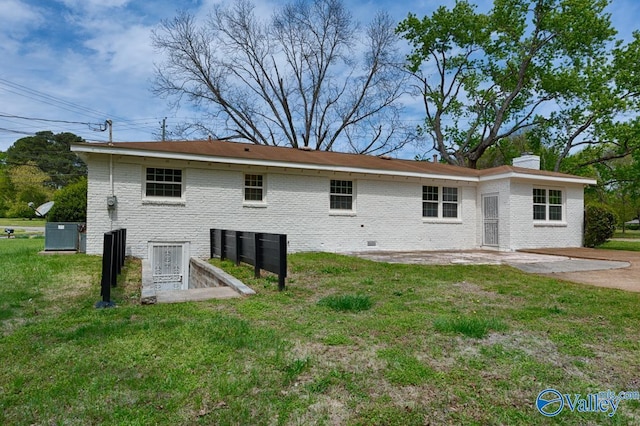 4407 Sparkman Dr NW, Huntsville, AL 35810 - back of property with a yard, brick siding, and a chimney