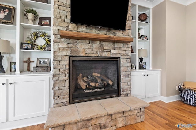 room details with hardwood / wood-style flooring and a fireplace