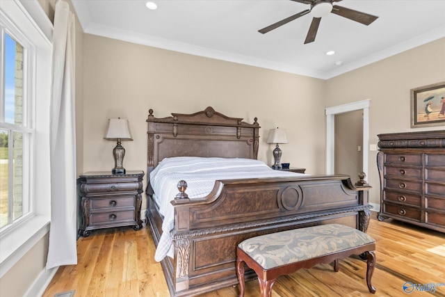 bedroom with light wood-type flooring, ceiling fan, and ornamental molding