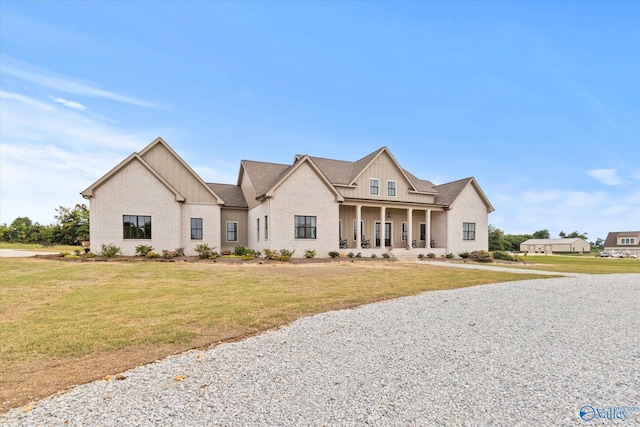 modern farmhouse with a porch and a front lawn