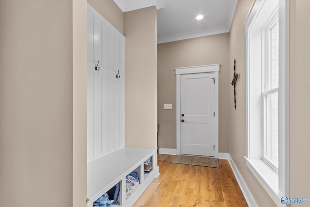 mudroom with crown molding and light hardwood / wood-style floors