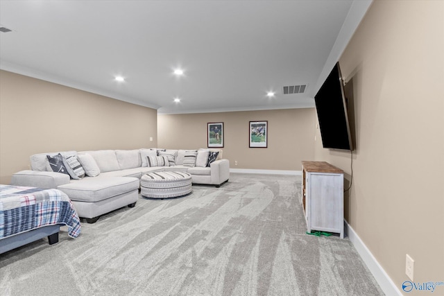 living room with ornamental molding and light carpet