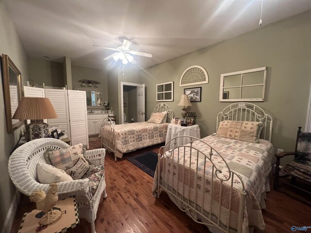 bedroom with dark wood-style floors, ensuite bath, and ceiling fan