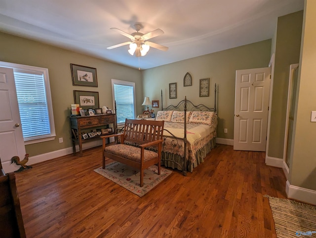 bedroom with dark hardwood / wood-style flooring and ceiling fan