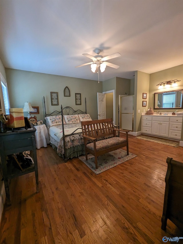 bedroom featuring white fridge, hardwood / wood-style flooring, and ceiling fan