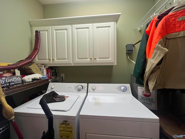 laundry area with independent washer and dryer and cabinets