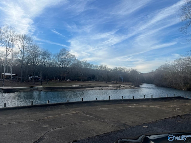 view of swimming pool with a water view