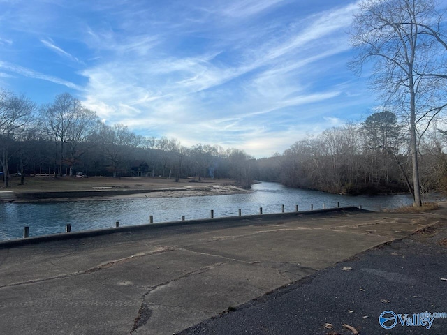 view of car parking with a water view