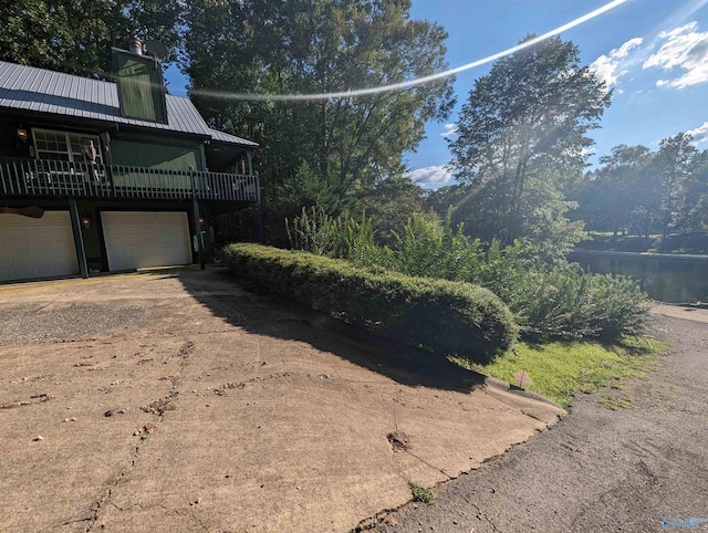 view of home's exterior featuring a water view and a garage