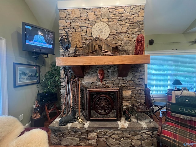 living room with a fireplace and vaulted ceiling