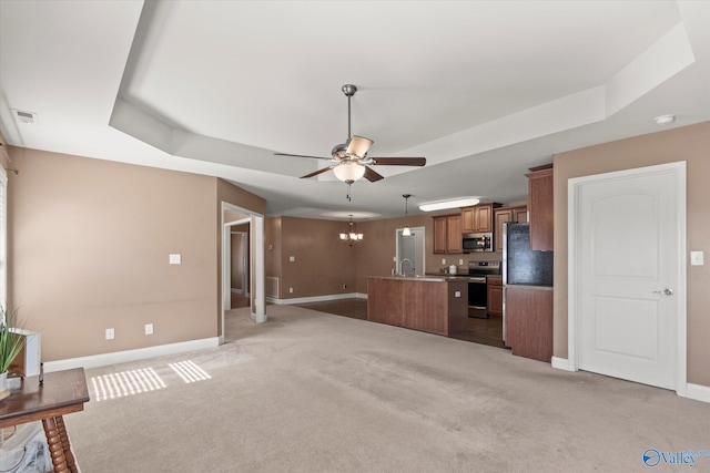 5008 Montauk Trl, Owens Cross Roads, AL 35763 - unfurnished living room featuring a tray ceiling, baseboards, ceiling fan, and light colored carpet