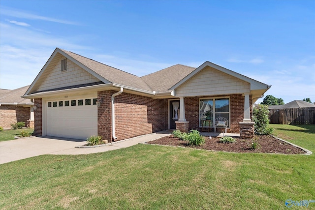 5008 Montauk Trl, Owens Cross Roads, AL 35763 - craftsman-style home featuring an attached garage, brick siding, concrete driveway, roof with shingles, and a porch