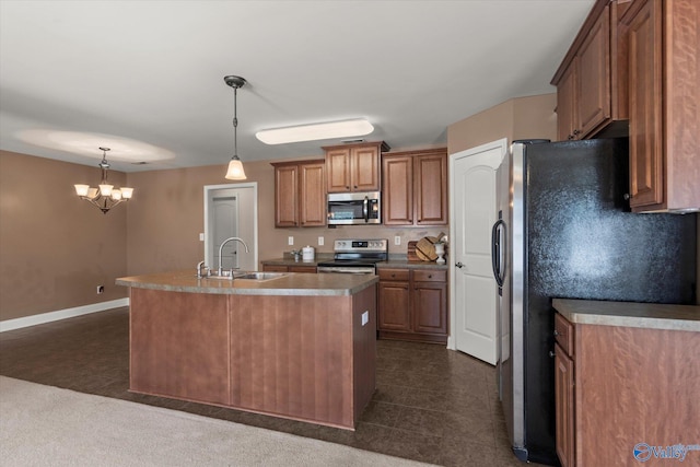 5008 Montauk Trl, Owens Cross Roads, AL 35763 - kitchen with appliances with stainless steel finishes, a sink, a kitchen island with sink, brown cabinets, and hanging light fixtures