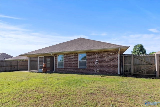 5008 Montauk Trl, Owens Cross Roads, AL 35763 - back of property with brick siding, a sunroom, and roof with shingles