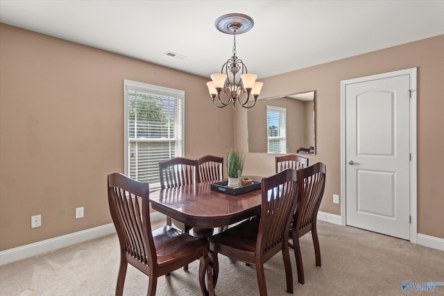 5008 Montauk Trl, Owens Cross Roads, AL 35763 - dining space featuring a chandelier, healthy amount of natural light, and light colored carpet