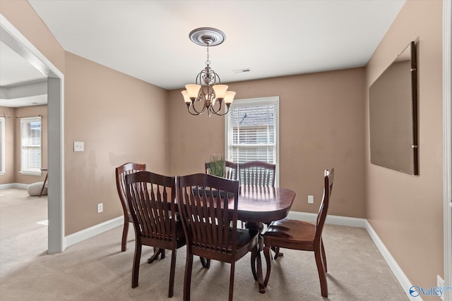 5008 Montauk Trl, Owens Cross Roads, AL 35763 - dining area featuring a chandelier, light carpet, healthy amount of natural light, and baseboards