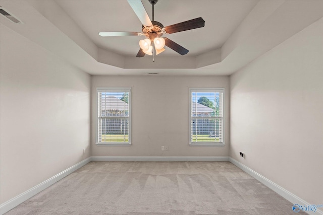 5008 Montauk Trl, Owens Cross Roads, AL 35763 - spare room featuring light colored carpet, healthy amount of natural light, baseboards, and a tray ceiling