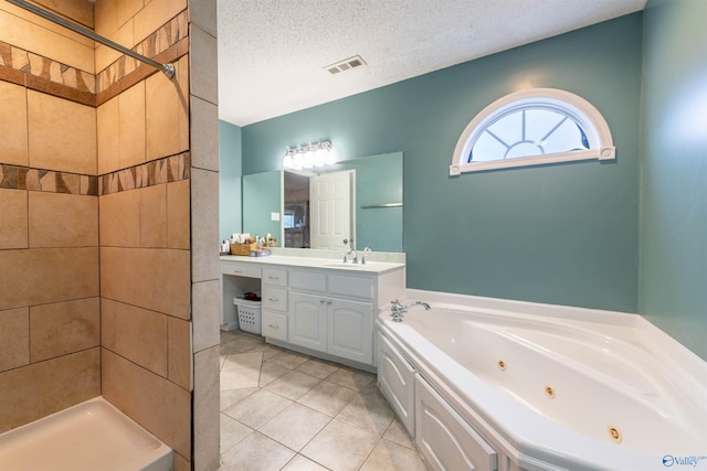 full bath with visible vents, a tub with jets, tile patterned flooring, a tile shower, and a textured ceiling