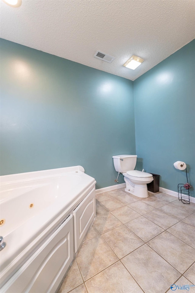 bathroom featuring baseboards, visible vents, toilet, and tile patterned floors