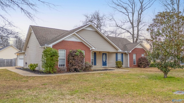 view of front of property with brick siding, a front lawn, and a shingled roof