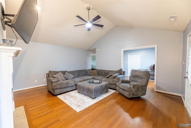 living area with lofted ceiling, baseboards, a ceiling fan, and wood finished floors