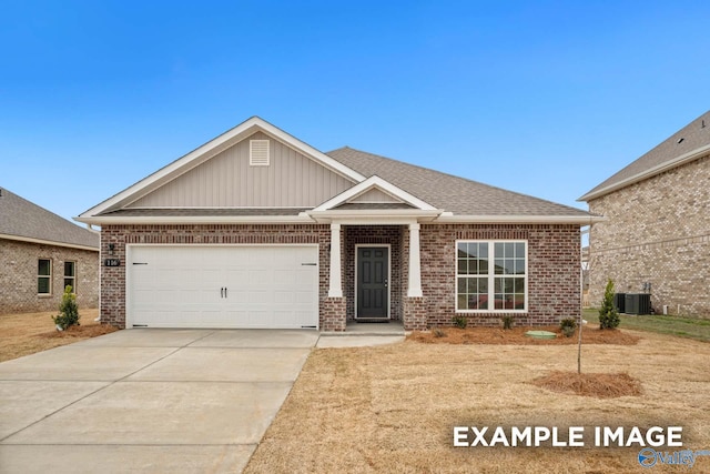 craftsman-style home featuring a garage, driveway, brick siding, and a shingled roof